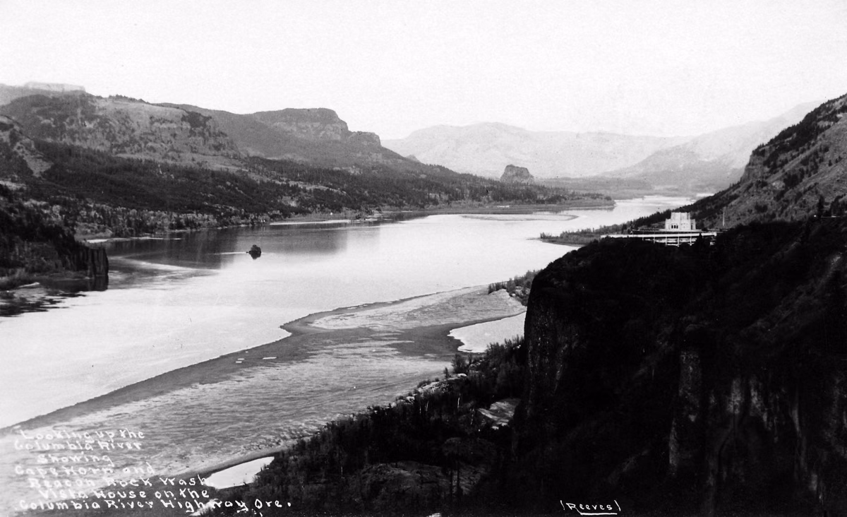 Historic black-and-white view up the Columbia River showing Cape Horn and Beacon Rock